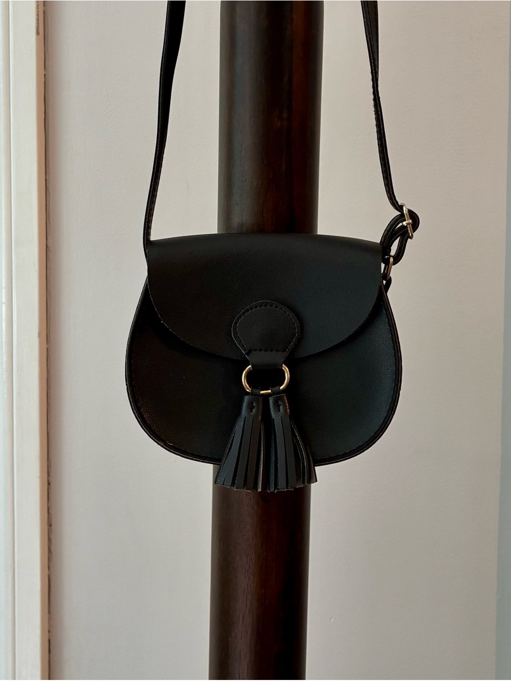Black Faux Leather Saddle Crossbody Bag with Tassel Detail